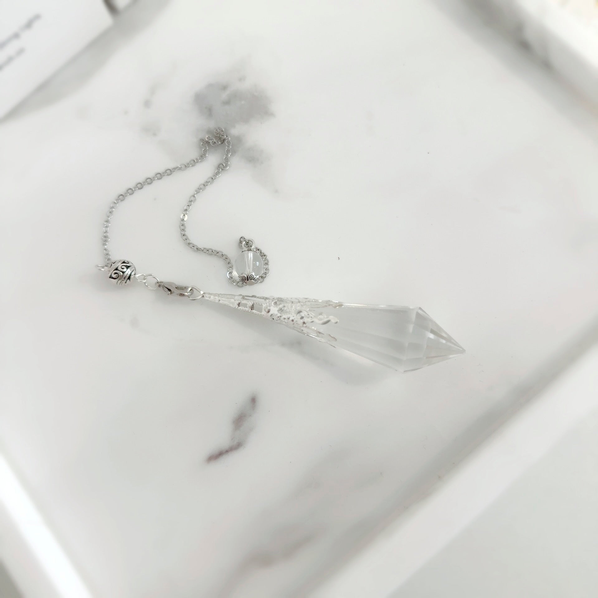 Close-up of Vogel Cut Quartz Crystal Pendulum – Enhancing Energy and Intention