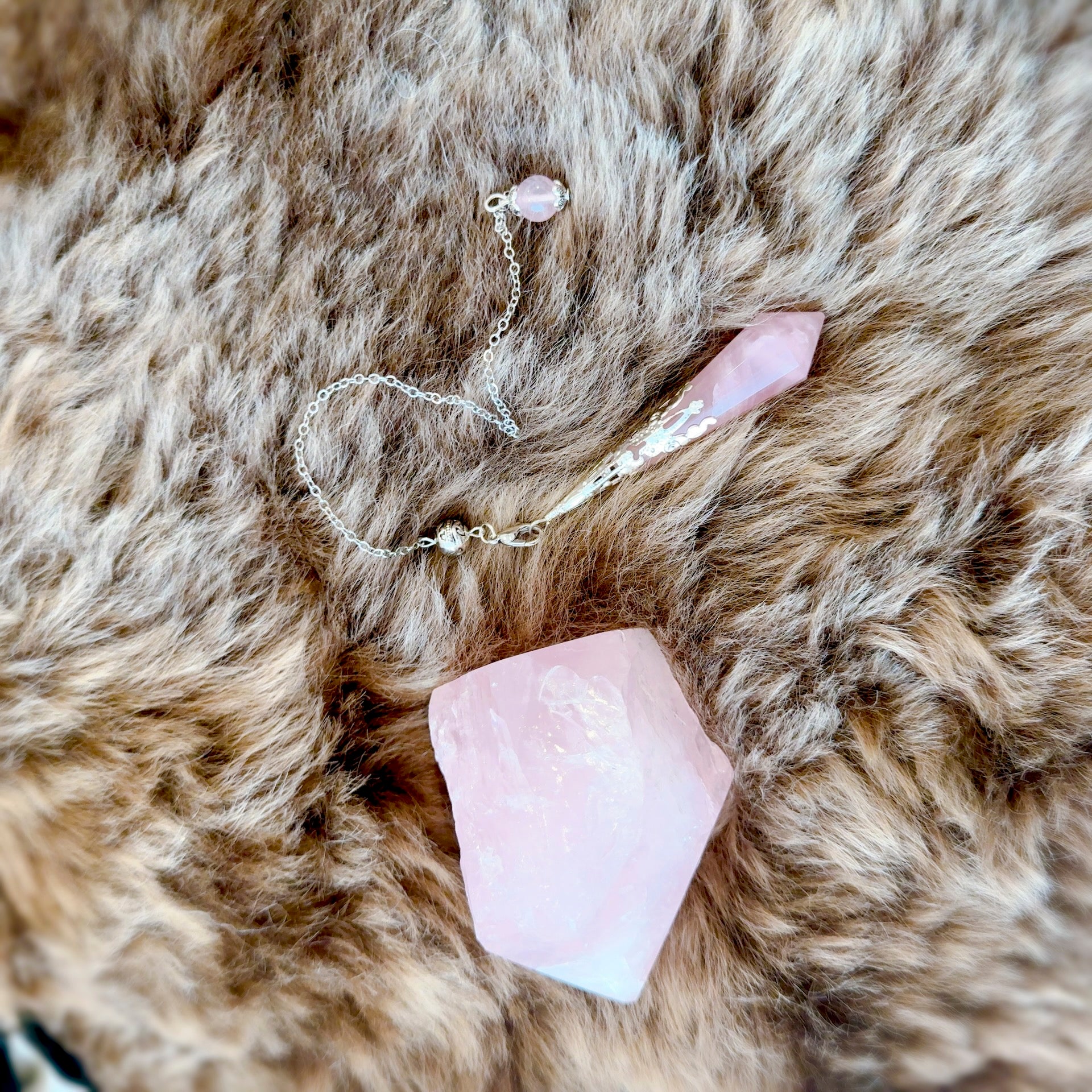 Close-up of Vogel Cut Rose Quartz Crystal Pendulum – Enhancing Love and Healing